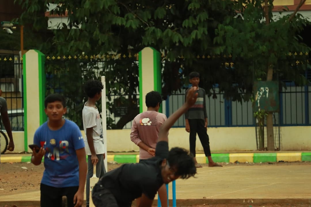 a group of young men playing a game of croquet