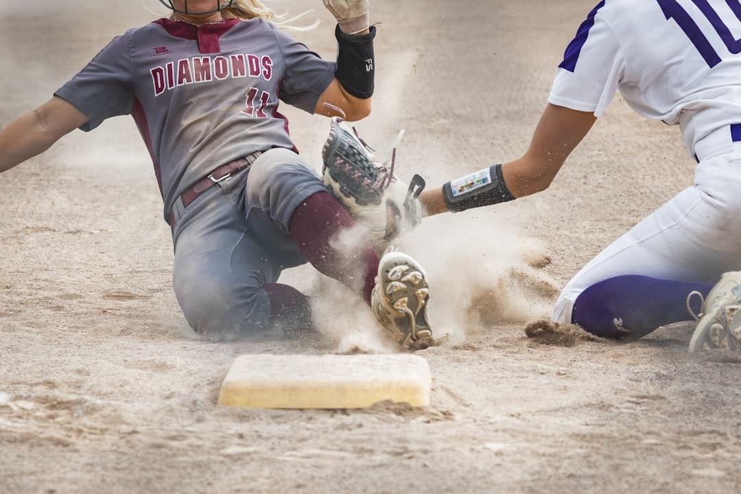 a baseball player sliding into a base during a game