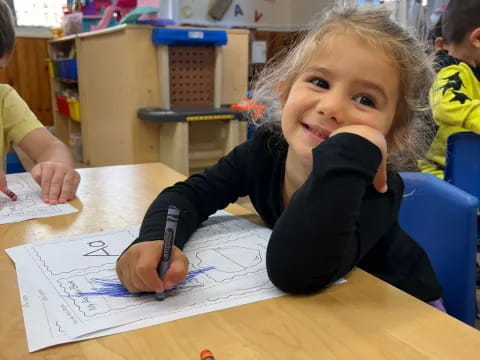 a girl sitting at a table