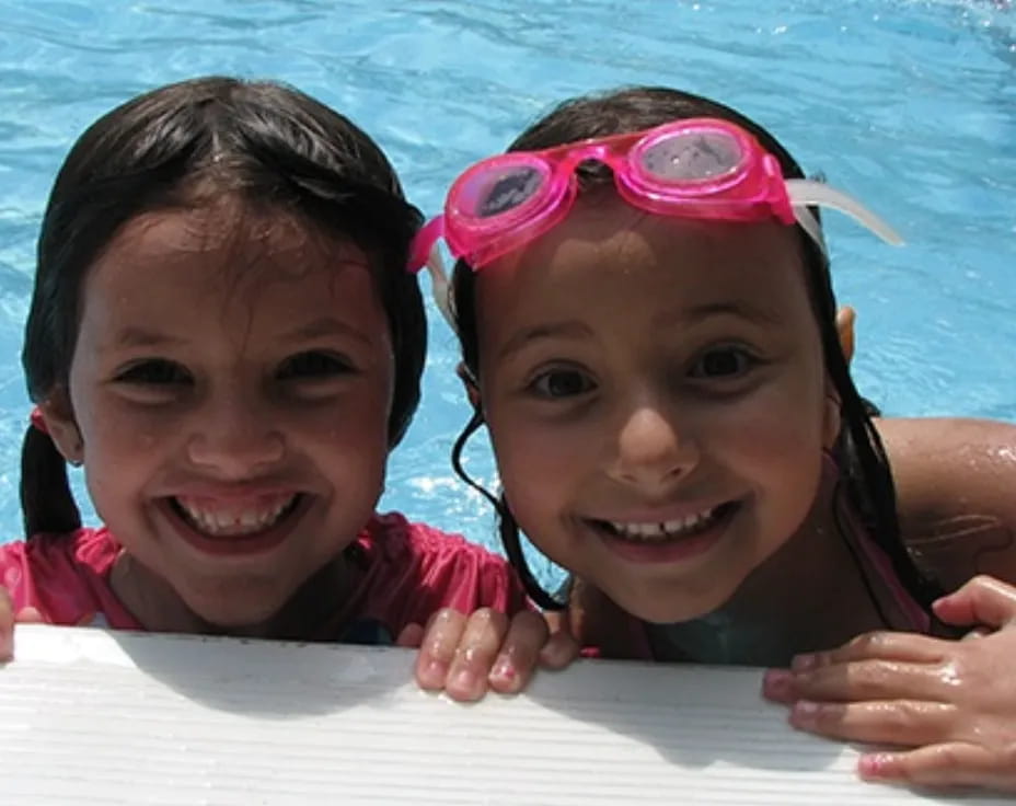 a couple of girls in a pool