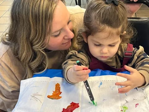 a person and a child painting