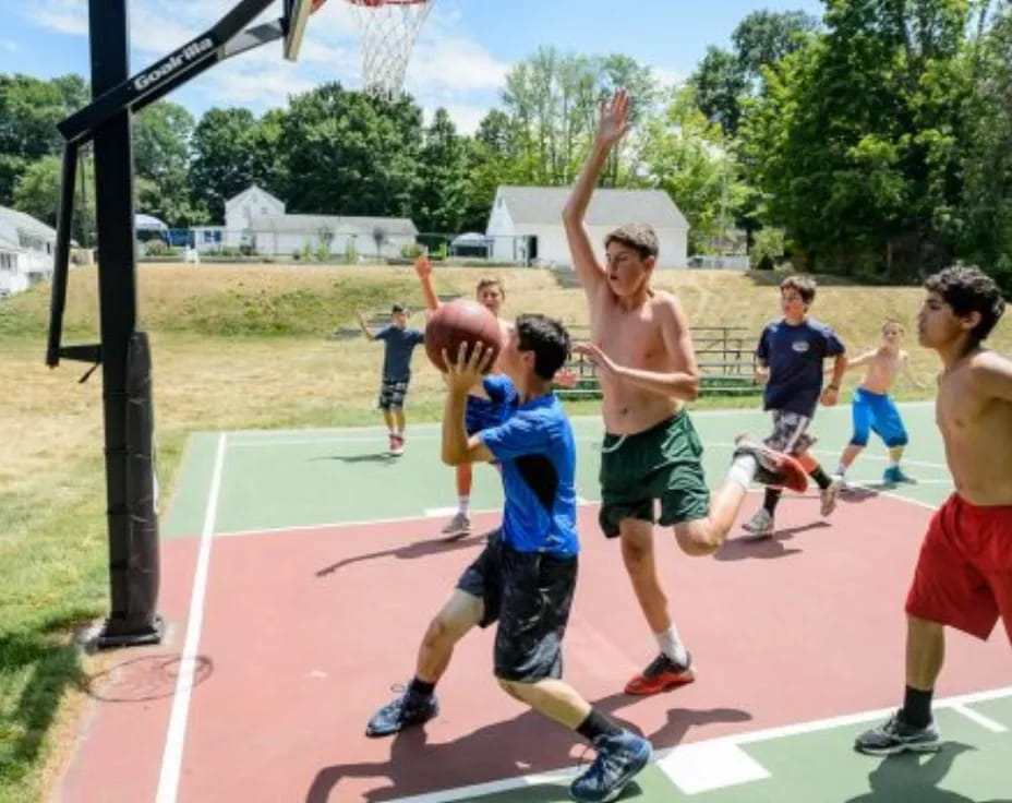 a group of boys playing basketball