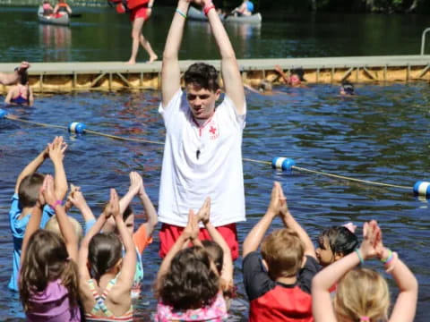 a person standing in a pool with children