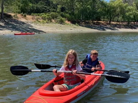 a couple of kids in a canoe