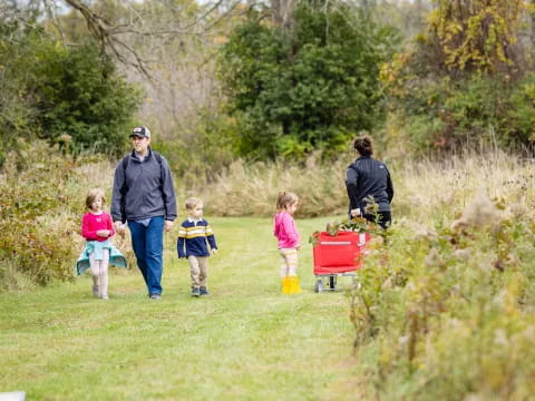 a group of people walking with children