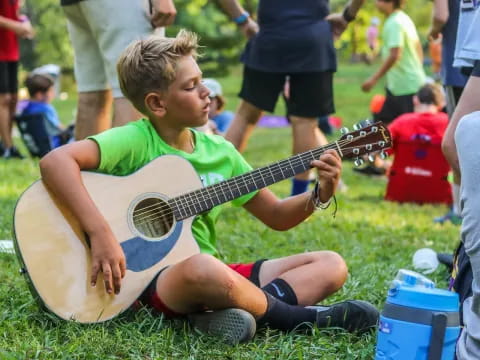 a boy playing a guitar
