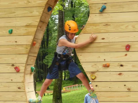 a person climbing a wooden wall