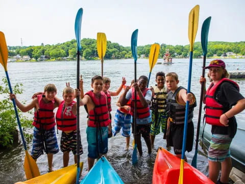 a group of people holding paddles