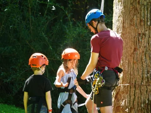 a person and kids wearing helmets