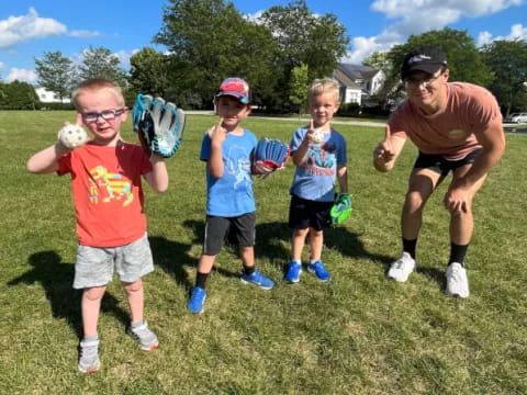 a group of kids playing baseball