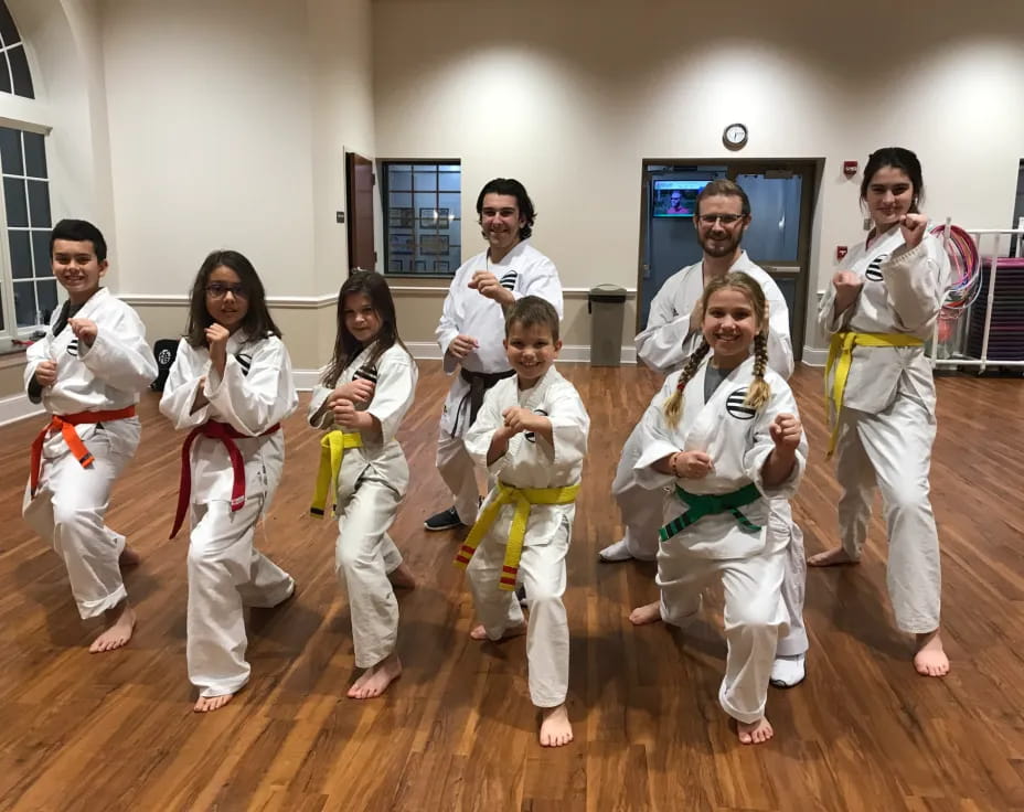 a group of people in karate uniforms