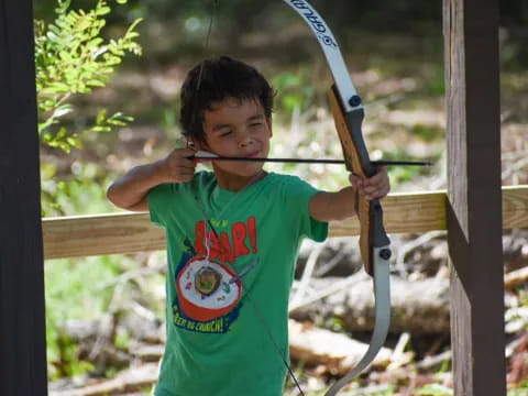 a boy holding a bow and arrow