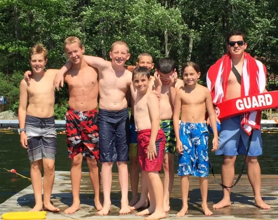 a group of men standing on a dock
