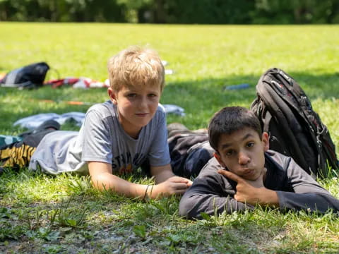 two boys lying on the grass