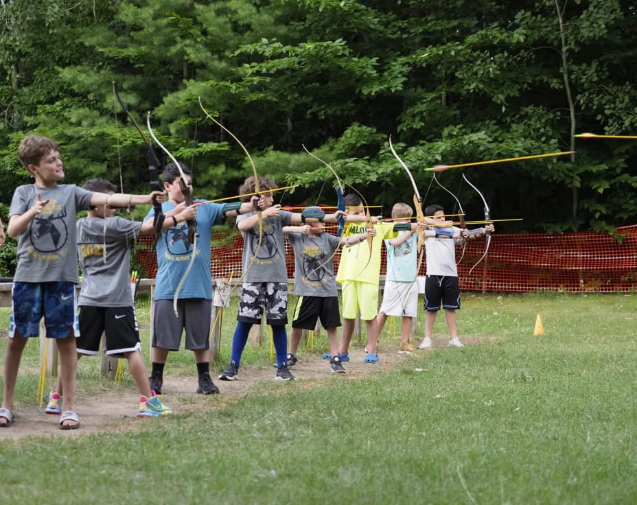 a group of people holding bows and arrows