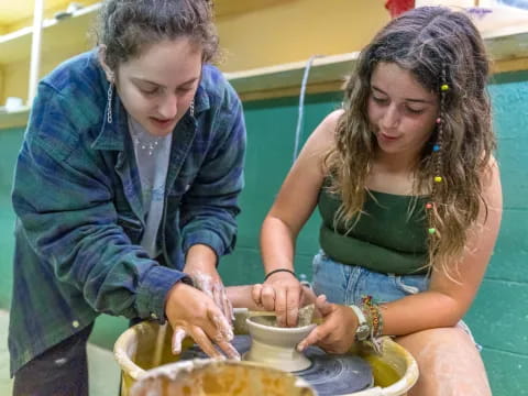 a man and a woman making a bowl of food