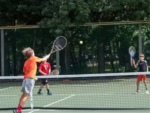 a group of people play tennis