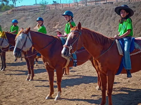 a group of people riding horses