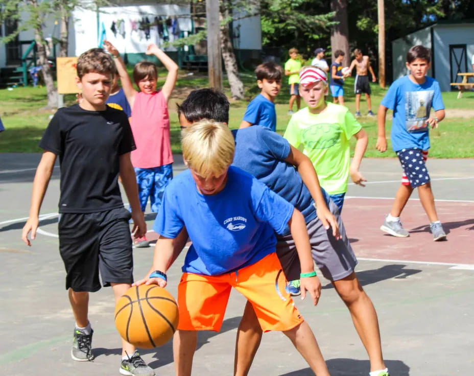 a group of kids playing basketball