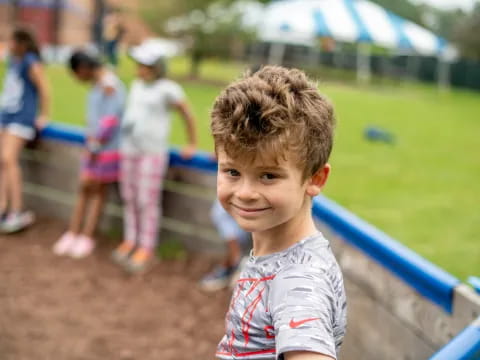 a boy smiling at the camera