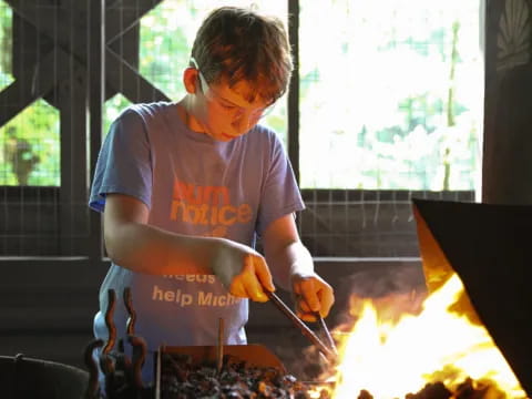 a man cooking food on a grill