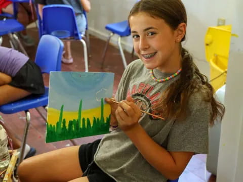 a young girl sitting at a desk