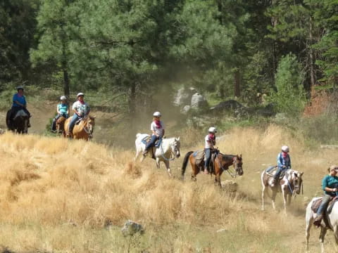 a group of people riding horses