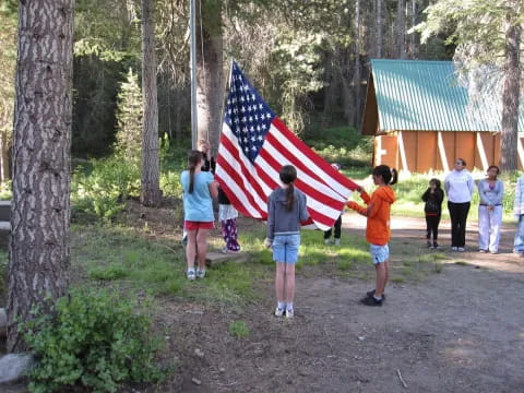 a group of people walking on a path with a flag