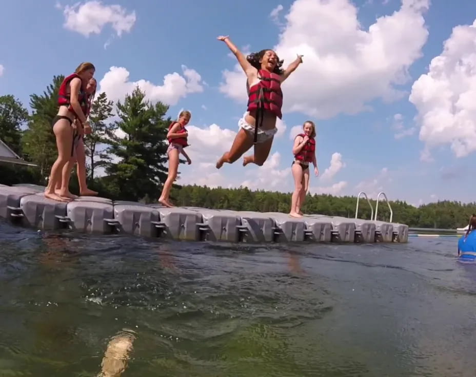 a group of people jumping into water