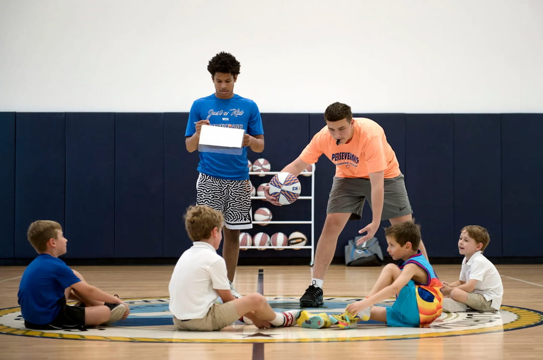 a group of kids playing basketball