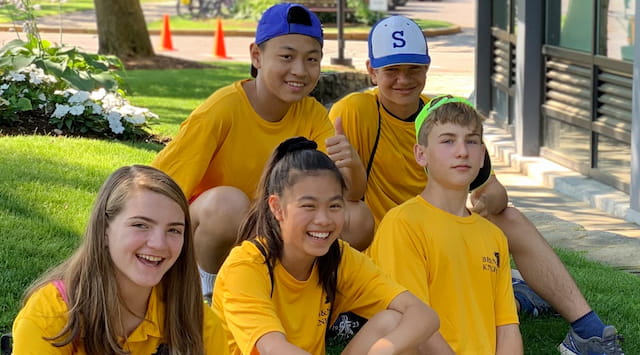 a group of people sitting on the grass