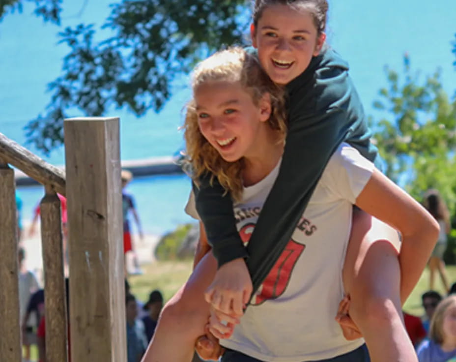 a woman carrying a man on her back