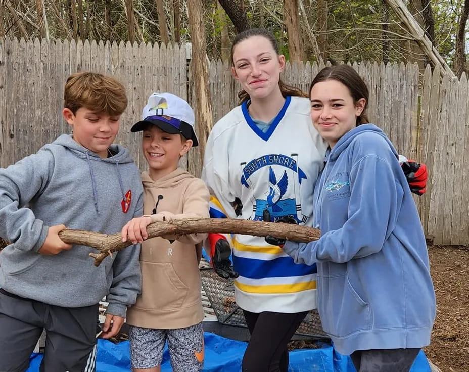 a group of people holding a fish