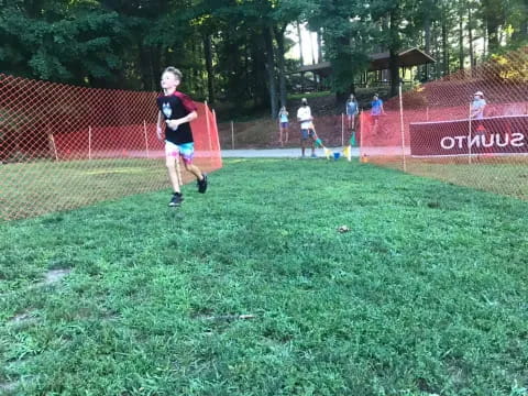 a boy running on a field