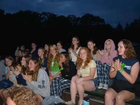 a group of people sitting on a bench