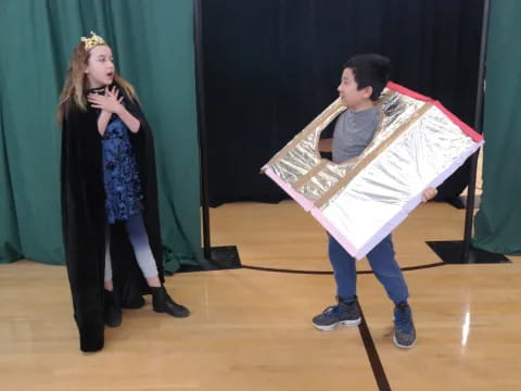 a boy and girl on a stage