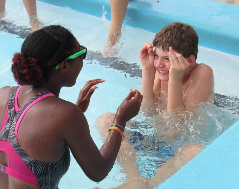 a person and a boy in a pool