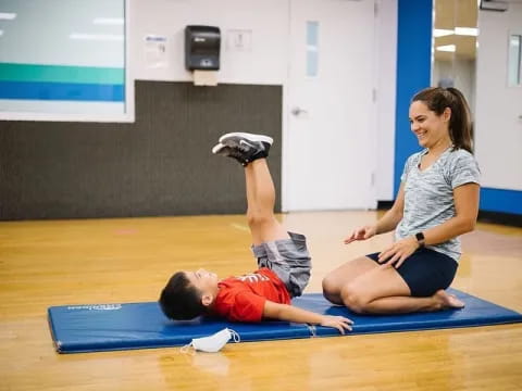 a woman and a boy exercising