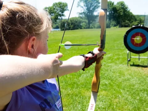 a person shooting a bow and arrow