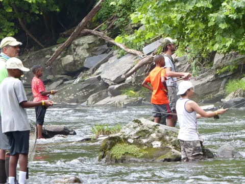 a group of people standing in a river