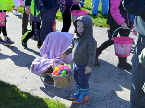 a child holding a basket of easter eggs