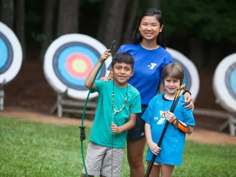 a group of kids holding bows and arrows