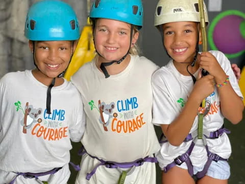 a group of girls wearing helmets and holding a balloon