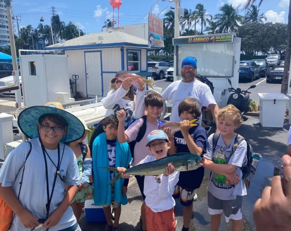 a group of people holding a fish