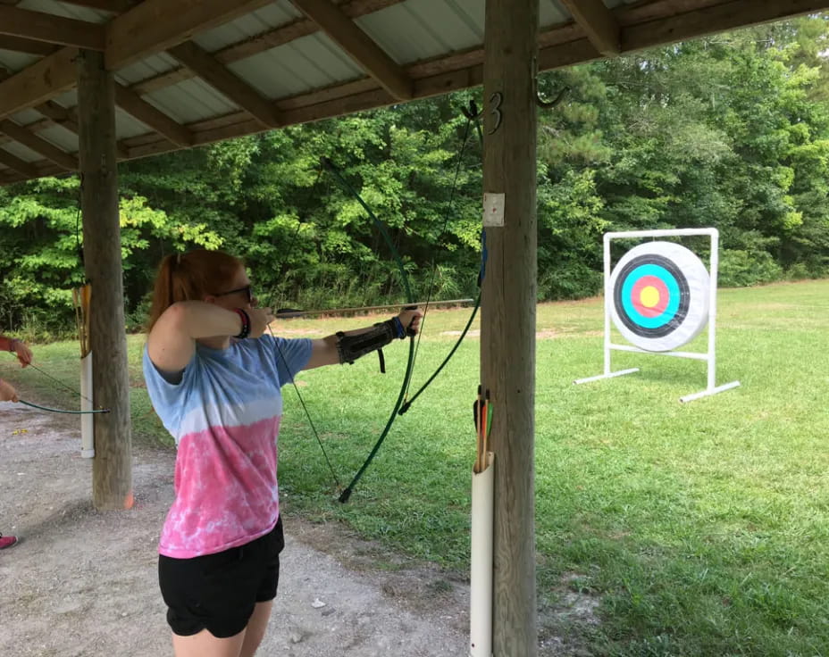 a person shooting a bow and arrow