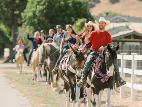 a group of people riding horses