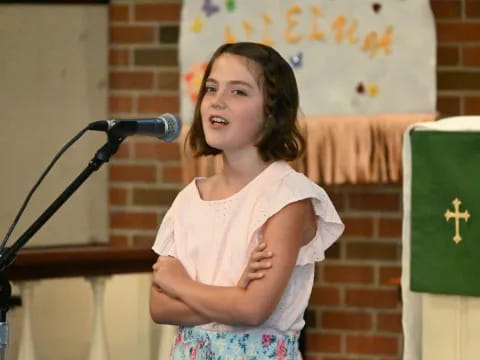 a girl standing in front of a microphone