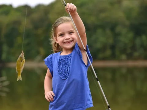 a girl holding a fish