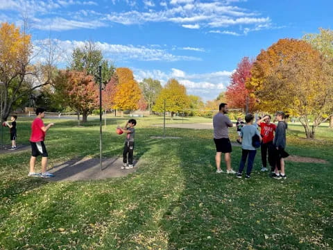 a group of people playing frisbee in a park