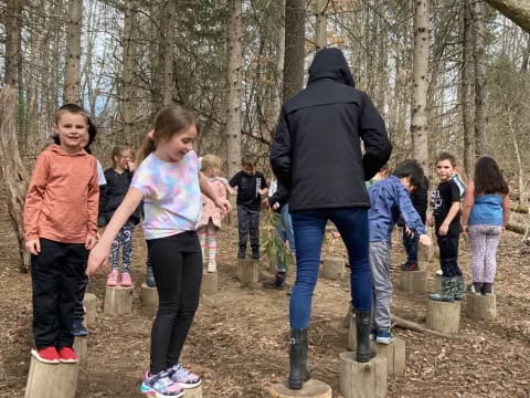 a group of people standing in a forest